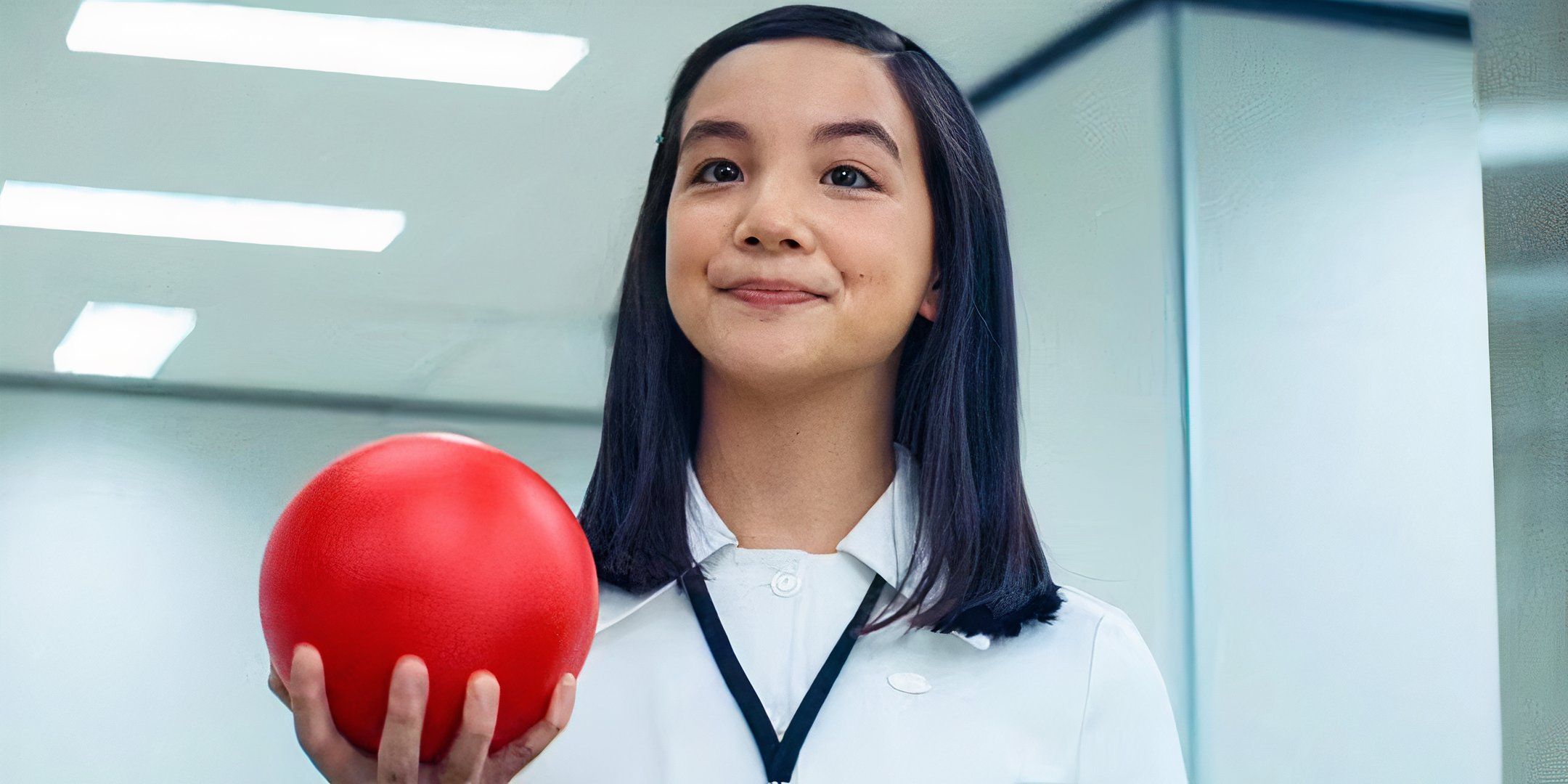 Miss Huang smiling and holding out a red ball in Severance season 2