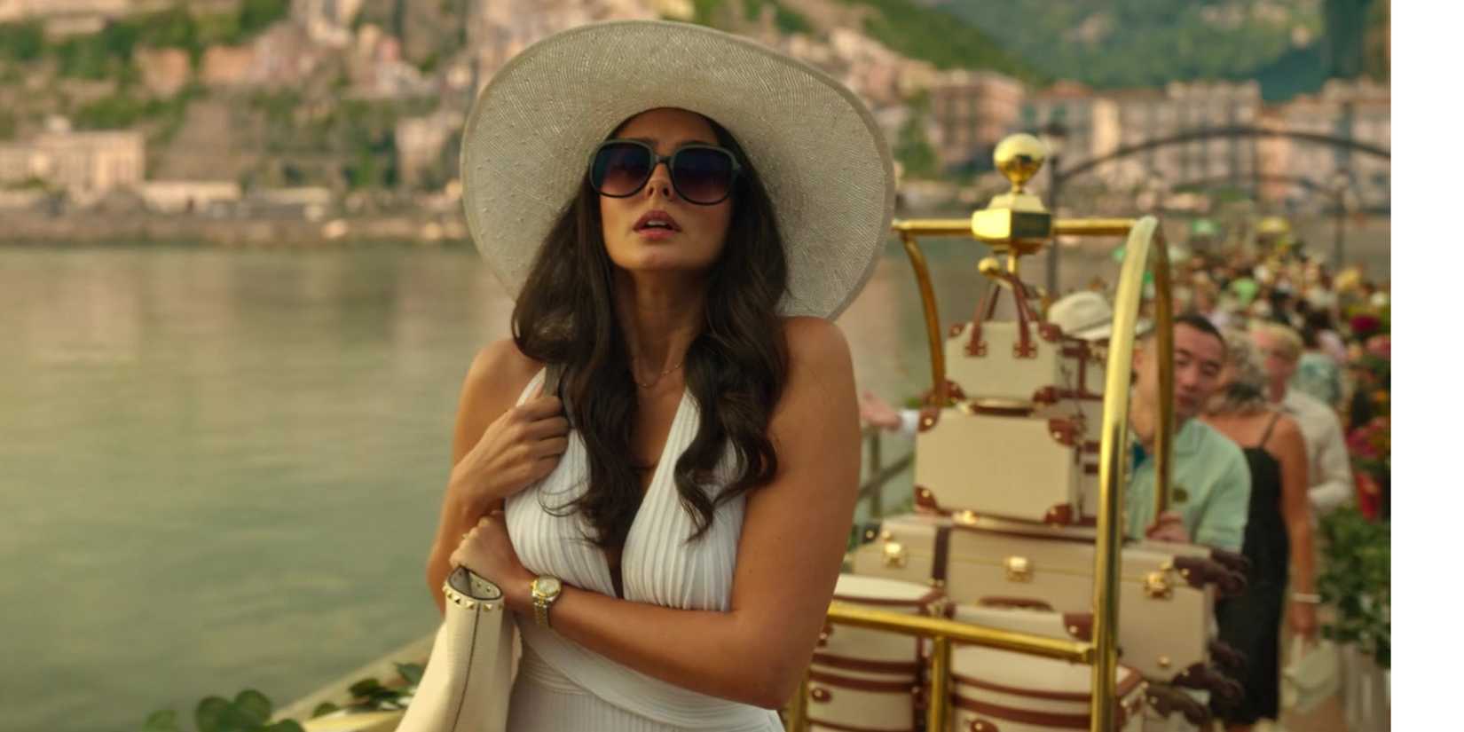 Pardis Saremi as Leila in a white dress, sun hat, and sunglasses