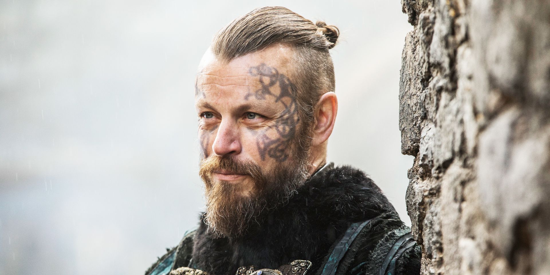 Harald Finehair standing and giving an eerie smile in Vikings