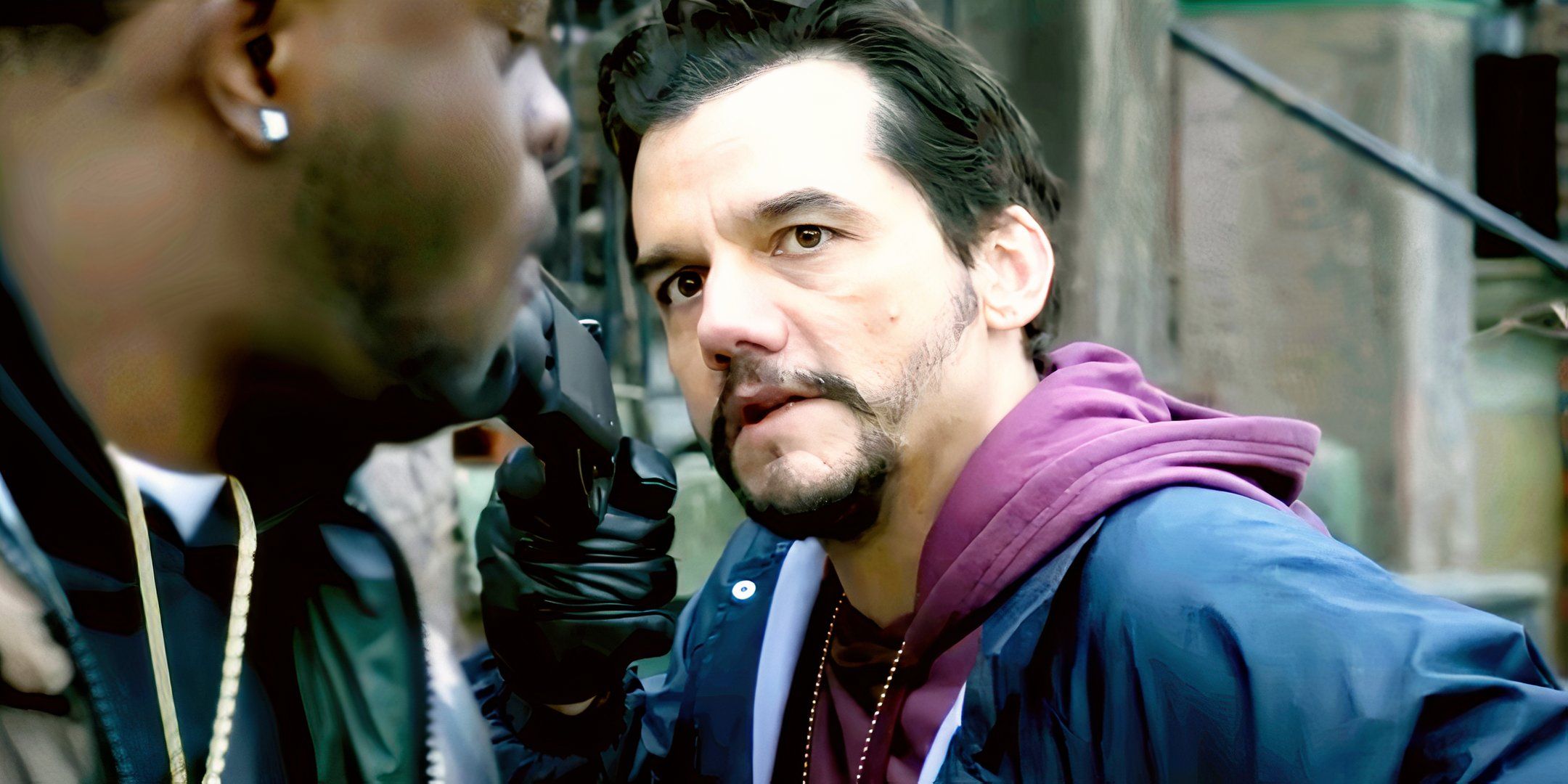 Wagner Moura as Manny pointing a shotgun at a drug dealer in Dope Thief