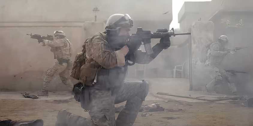 Three Navy SEALS aiming their guns in different directions in Warfare