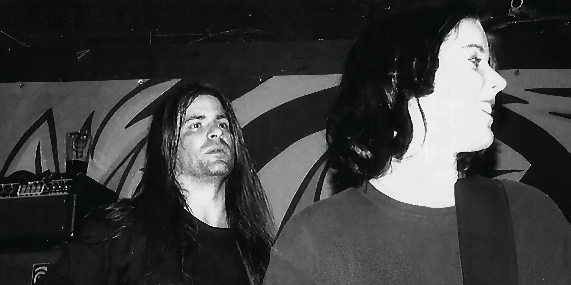 Black and white image of Weakling rock members with the male looking serious and the female smiling
