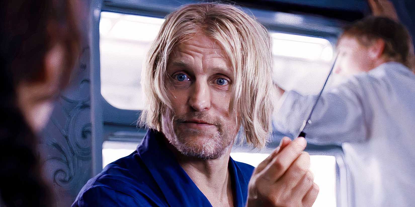 Woody Harrelson holding up a knife as Haymitch Abernathy in The Hunger Games