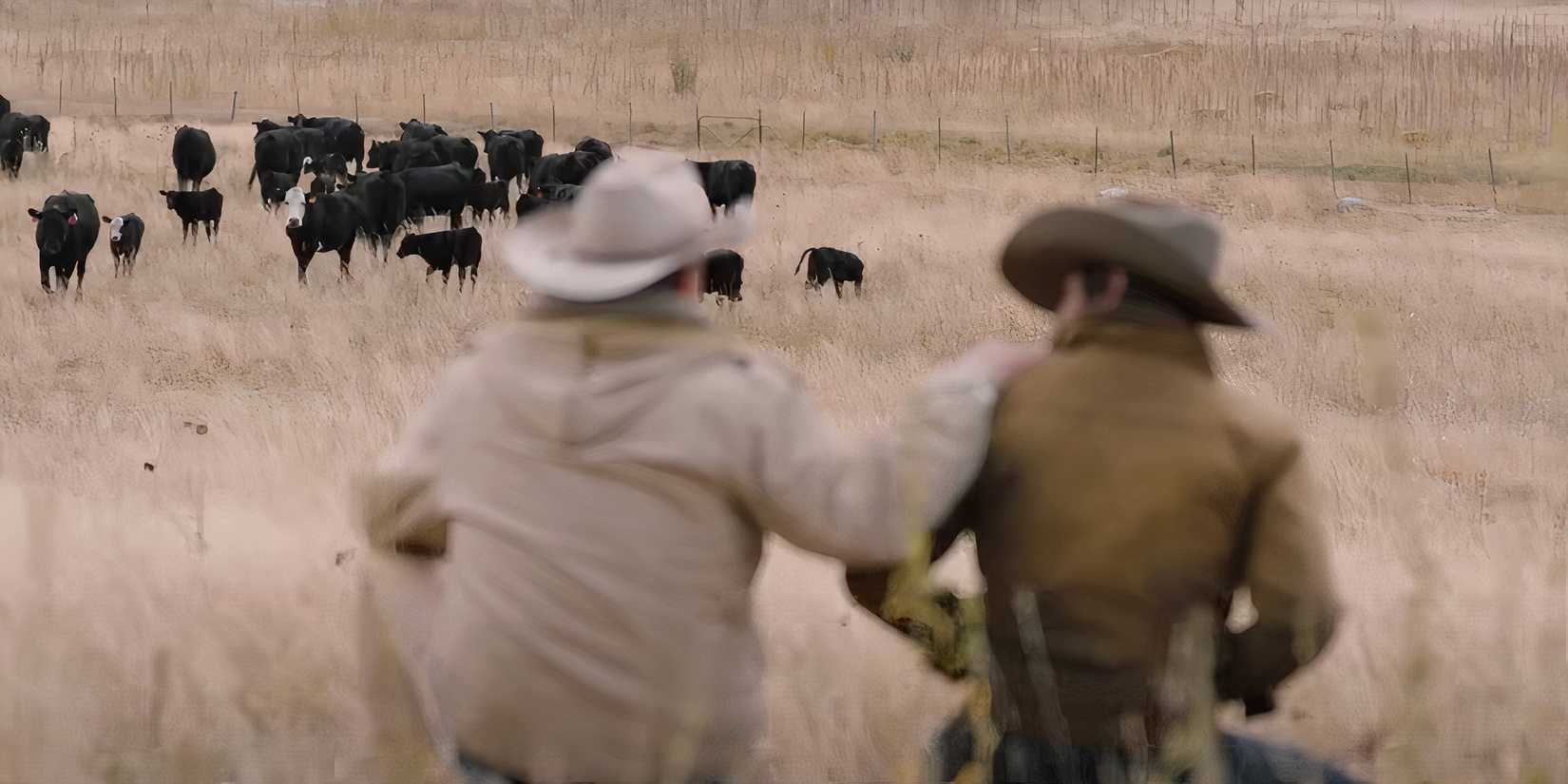 Kevin Costner's John Dutton puts his hand on another cowboy's shoulder in Yellowstone season 1
