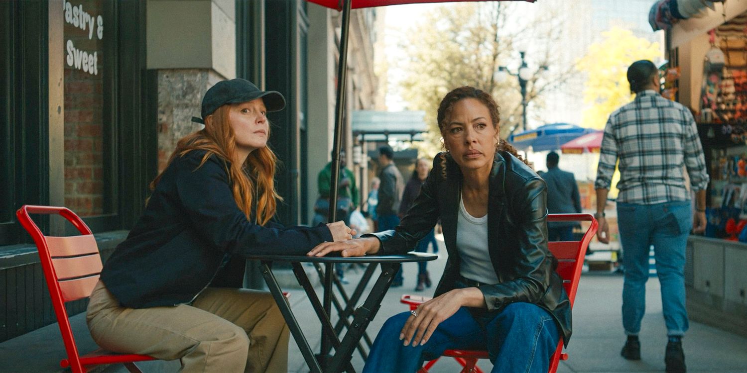 Van (Lauren Ambrose) and Taissa (Tawny Cypress) sitting at a coffee shop table, very observant in Yellowjackets Season 3 Ep 4