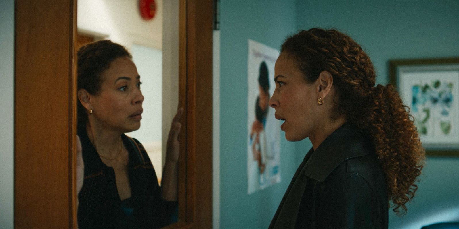 In a hallucination, Taissa (Tawny Cypress) staring at another version of herself behind a window in Yellowjackets Season 3 Episode 8