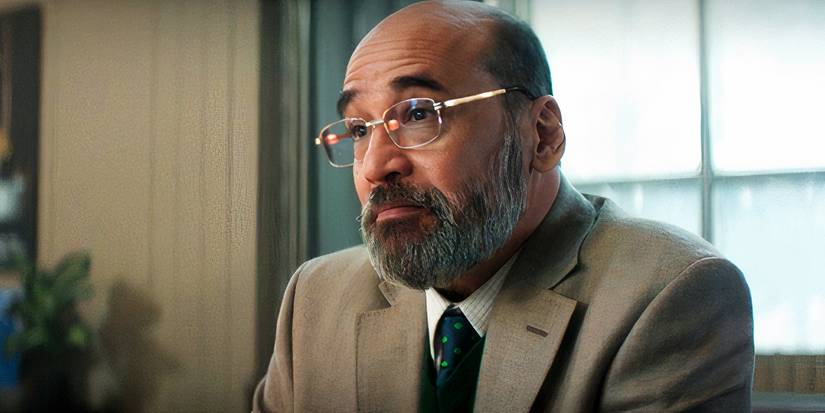 Yusuf Khan sitting at a desk in a bank in Daredevil: Born Again (2025)