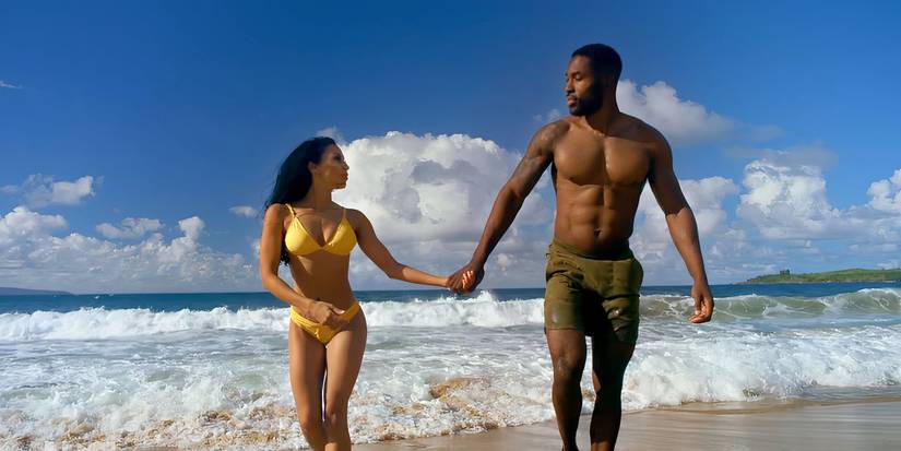 Javen Butler and Shari Ligons wearing swimsuits and walking on a beach on USA Network's Temptation Island season 1