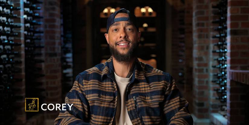 Million Dollar Secret's Corey Niles sitting in a confessional in a flannel and backwards hat