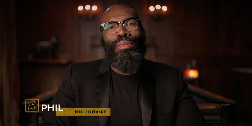 Million Dollar Secret's Phillip Roundtree sitting in a confessional in a black suit