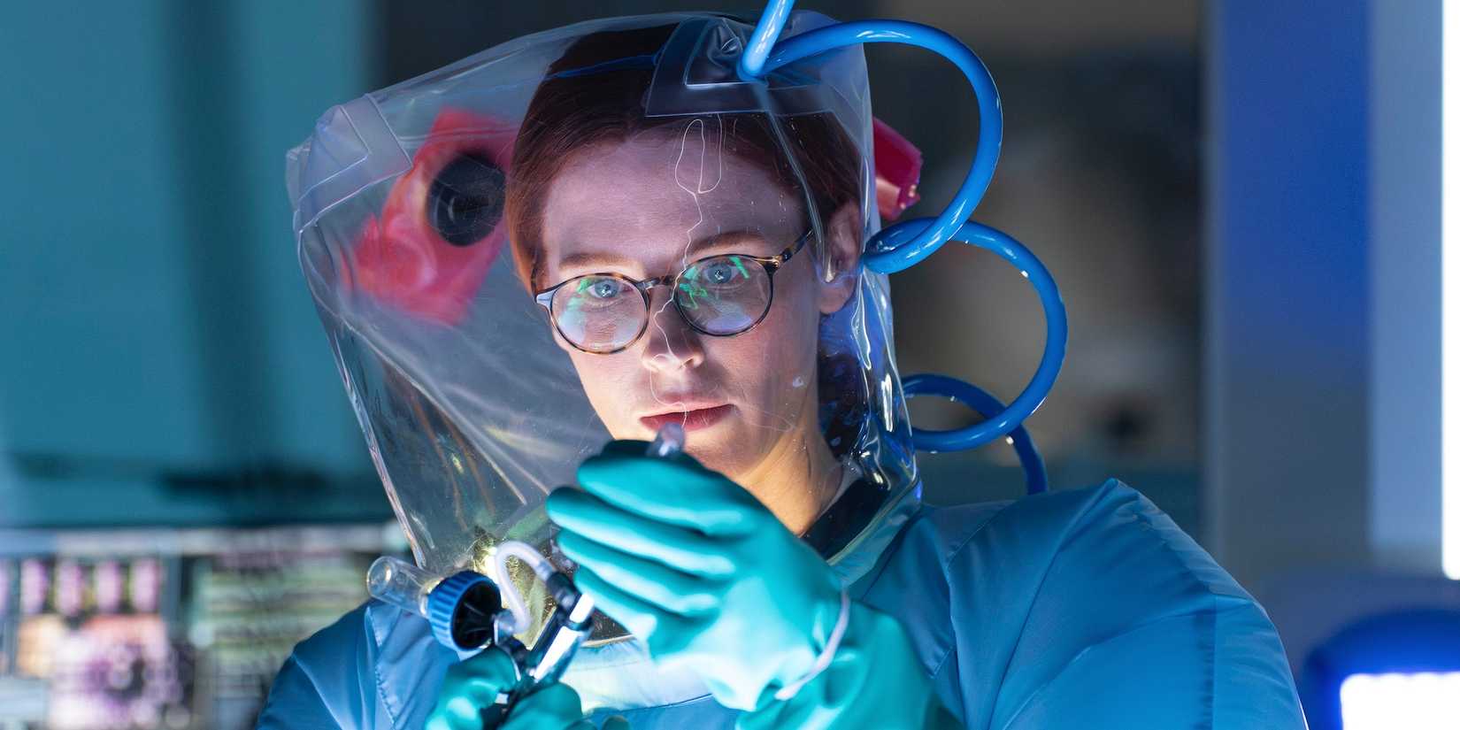 Bridget Regan as Moira in 9-1-1 season 8, episode 14 wearing protective lab gear.