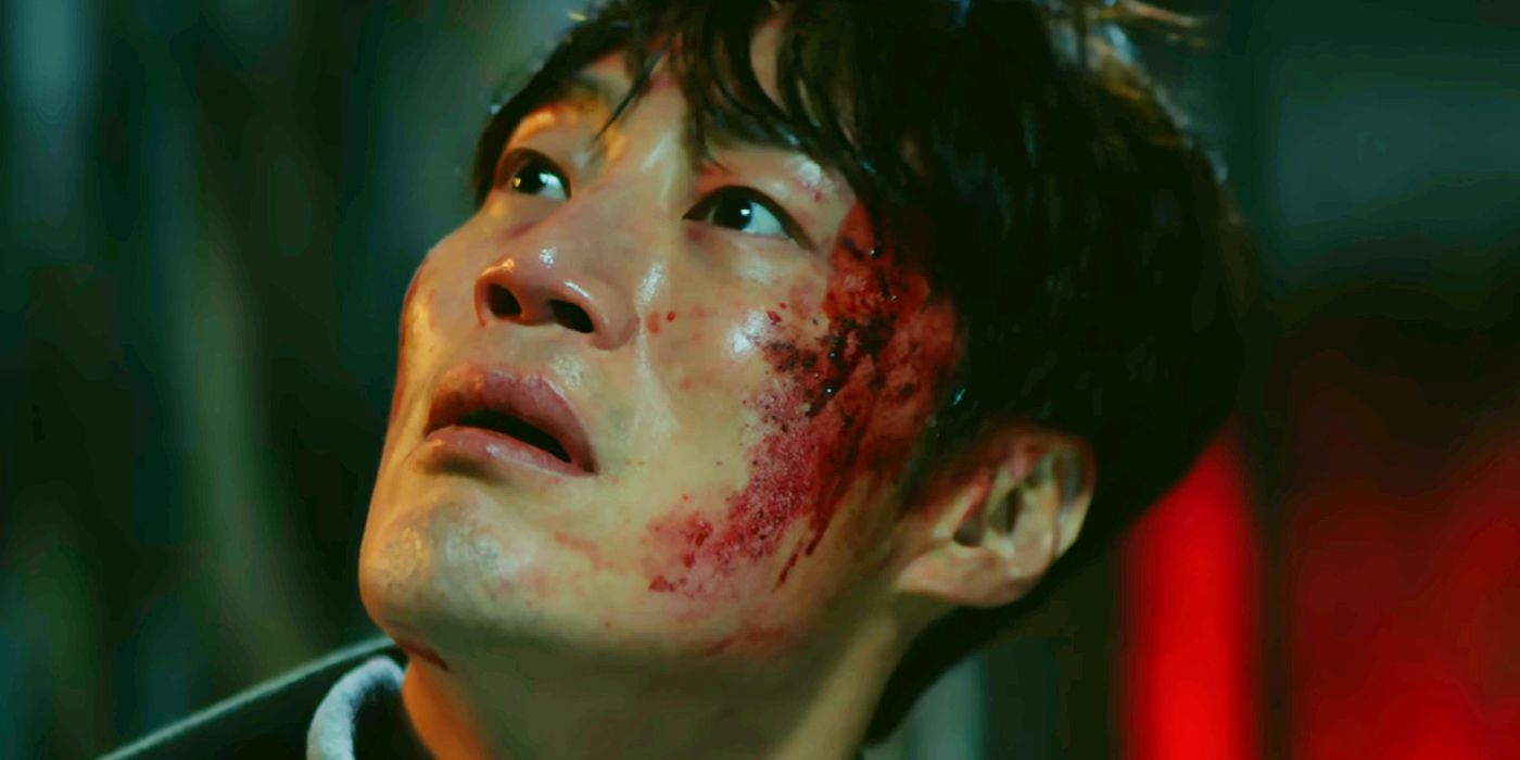 A character with a bloody face looking upward in Karma season 1