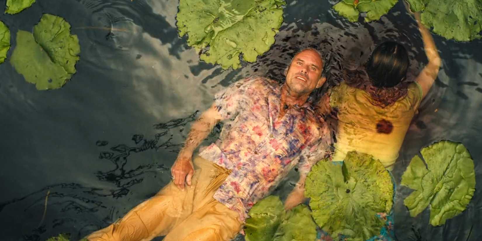 A dying Rick looks up smiling in the water next to Chelsea's dead body in The White Lotus' season 3 finale