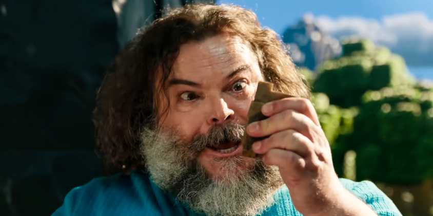 Steve (Jack Black) looking at an item in his hand in A Minecraft Movie