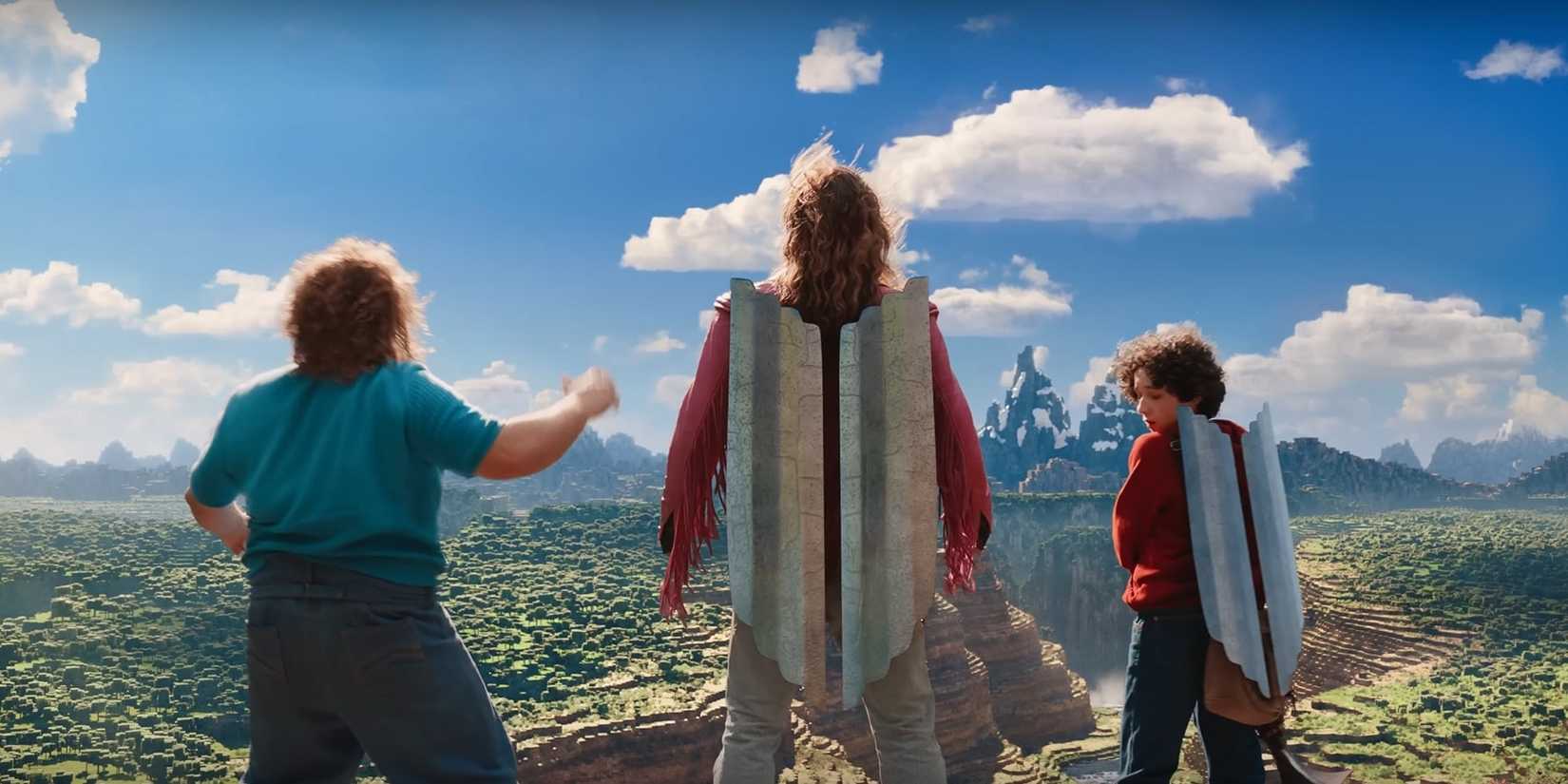 Jack Black as Steve standing next to Jason Momoa as Garrett and Sebastian Hansen as Henry with elytras on in A Minecraft Movie