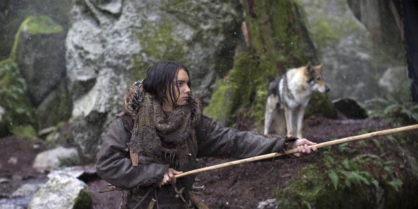 Keda brandishing his spear with a wolf in the distance in Alpha