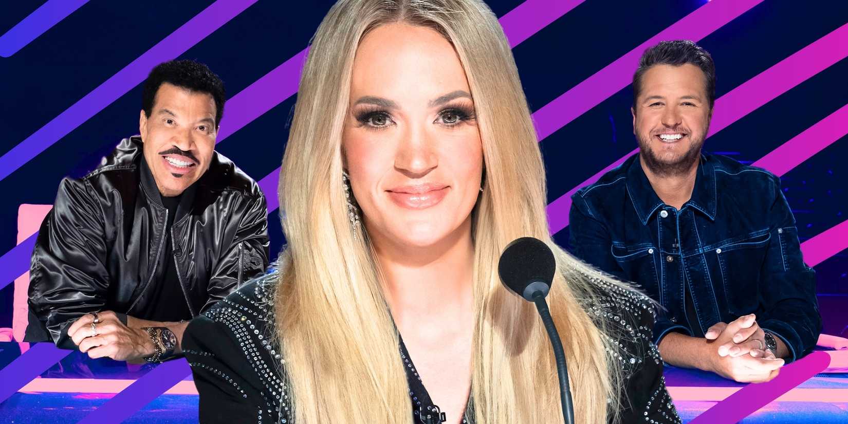 American Idol’s Carrie Underwood smiles in the foregrouund, with Lionel Richie and Luke Bryan smiling in the background.
