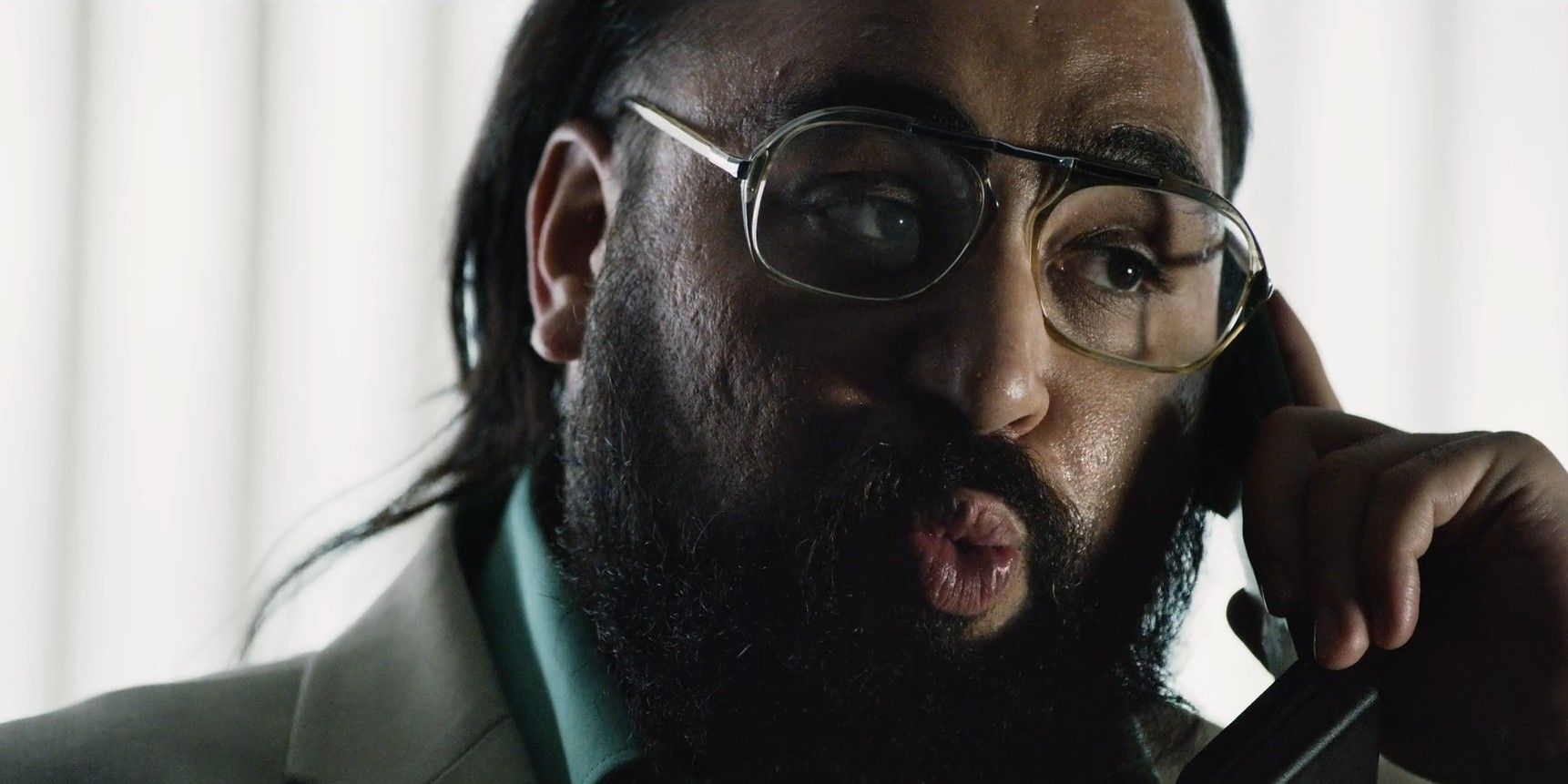 Asim Chaudhry as Mohan Thakur talking on the phone in Black Mirror: Bandersnatch