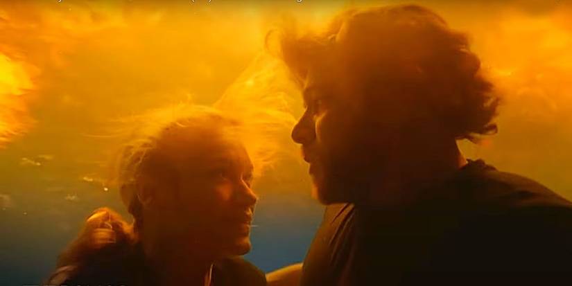 Bode (Max Thieriot) and Audrey (Leven James) underwater as a fire rages above in Fire Country.