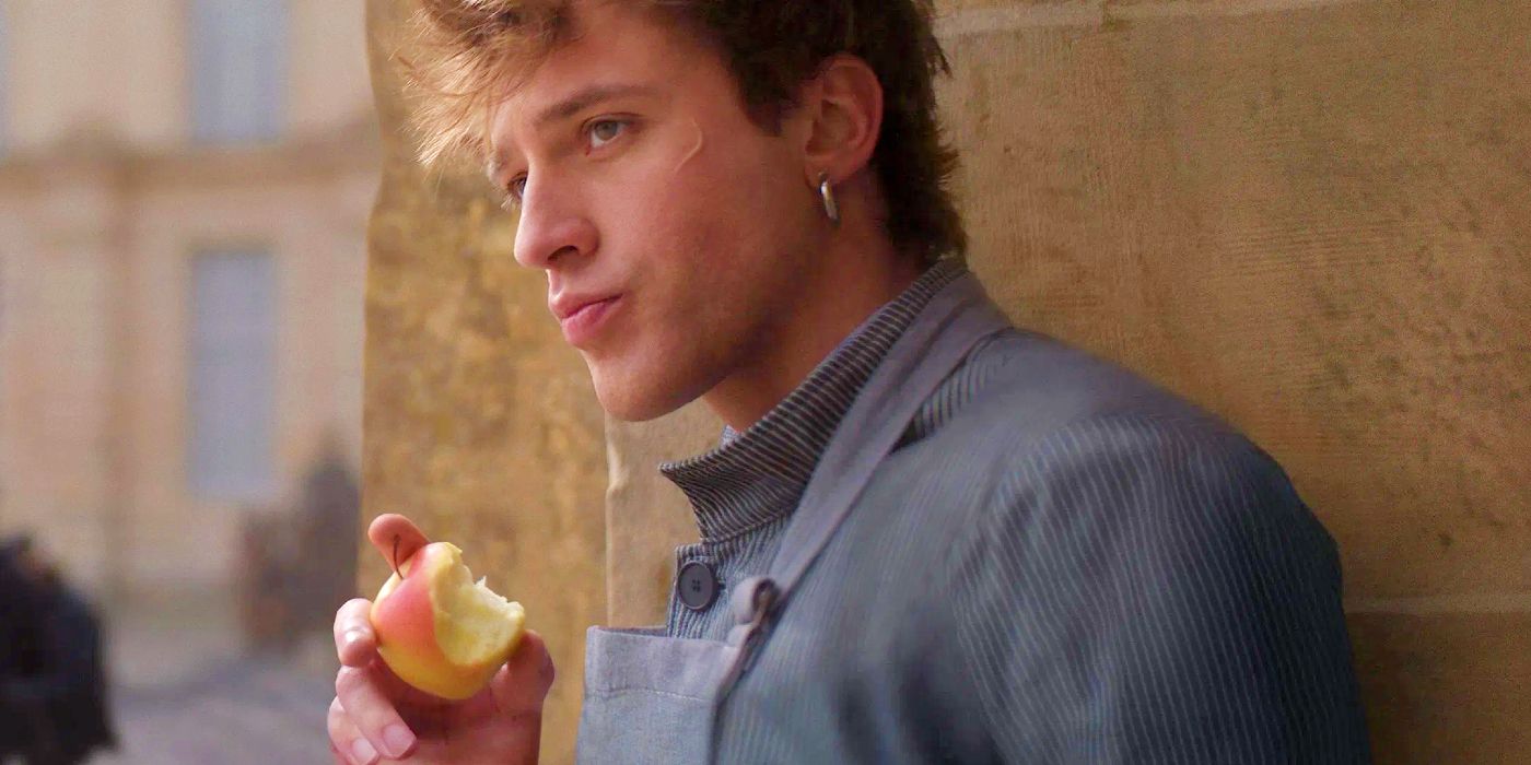 Careme eating an apple by a wall in Careme