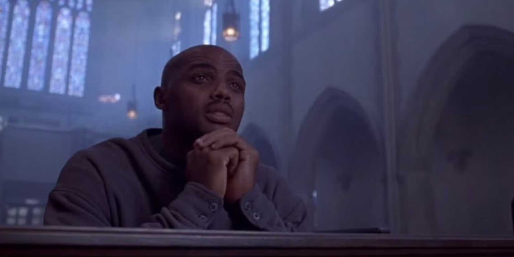 Charles Barkley praying in a church in Space Jam