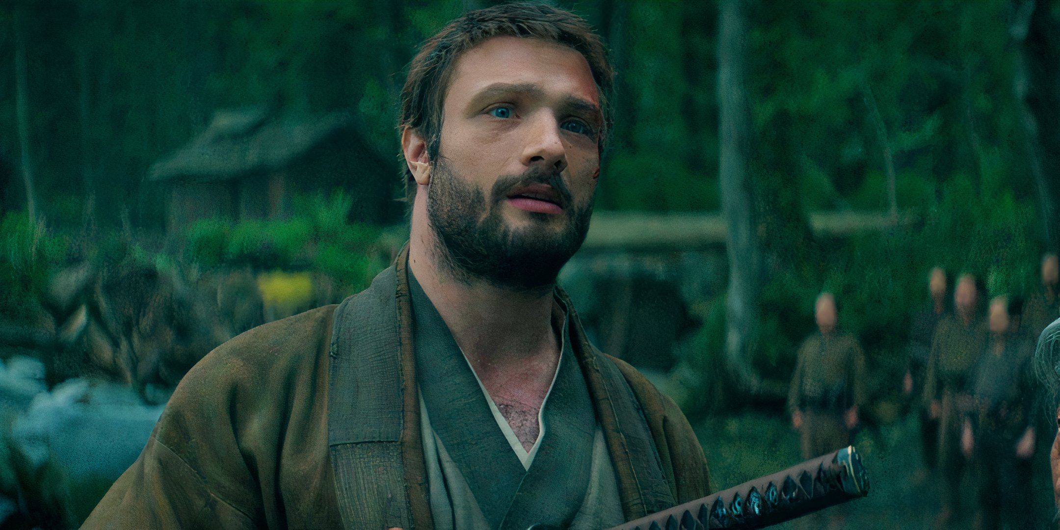 Cosmo Jarvis as John Blackthorne stands on a beach with a sword in Shogun season 1