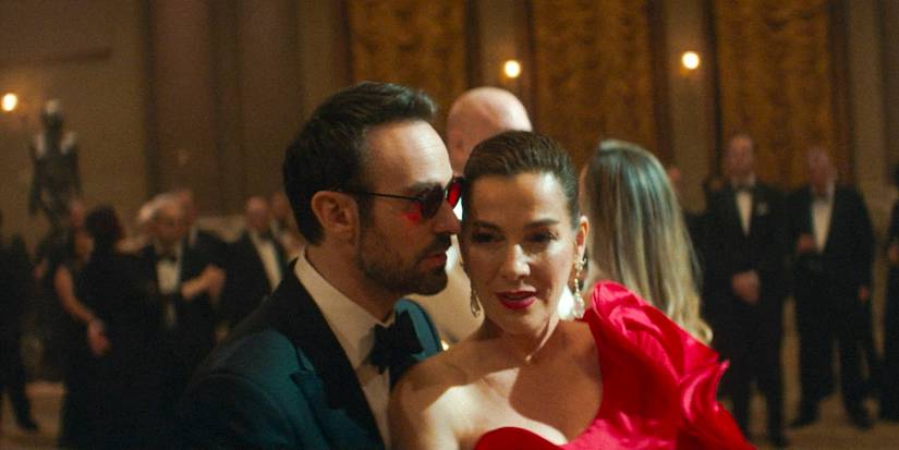Matt Murdock (Charlie Cox) whispering in Vanessa's (Ayelet Zurer) ear during the "Isle of Joy" gala in Daredevil: Born Again Season 1 Ep 8