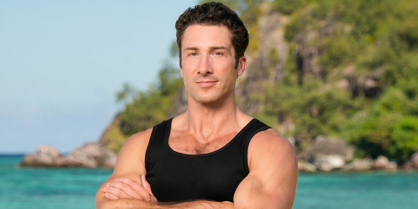 David Kinne from Survivor 48 posing on a beach with his arms crossed over his chest.
