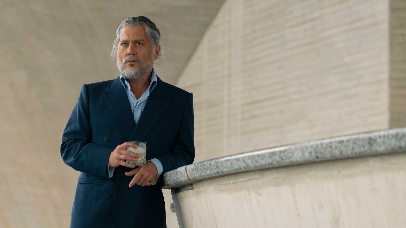 Day Drinker Johnny depp wearing a dark suit holding drink glass