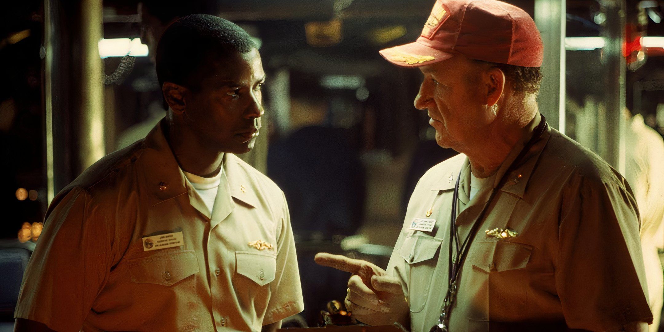 Gene Hackman points his finger at Denzel Washington during a discussion. 