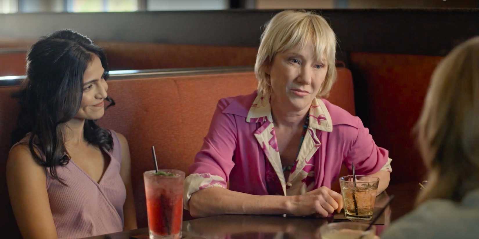Anne Heche as Katrina sitting in a restaurant booth next to Sharayu Mahale in Frankie Meets Jack