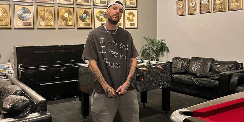 Too Hot To Handle: Italy season 1 Fred De Palma in a room with the vinyl records mounted on the wall.