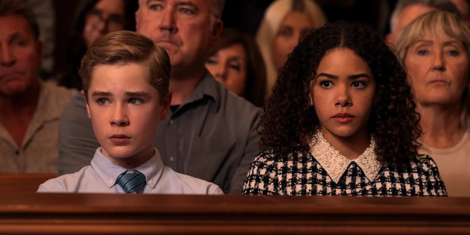 Austin and Ginny looking worried while sitting in a courtroom in Ginny & Georgia season 3