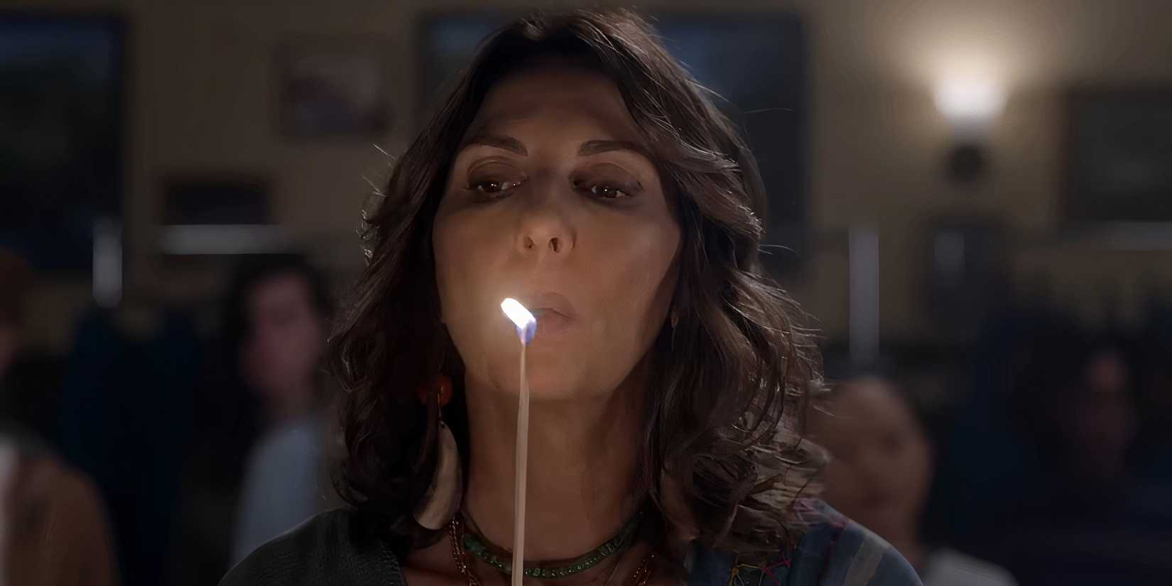 Gina Bellman as Sophie blowing out a candle in Leverage: Redemption Season 3