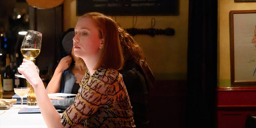 Hannah Einbinder as Ava Daniels having a drink at a bar in Hacks