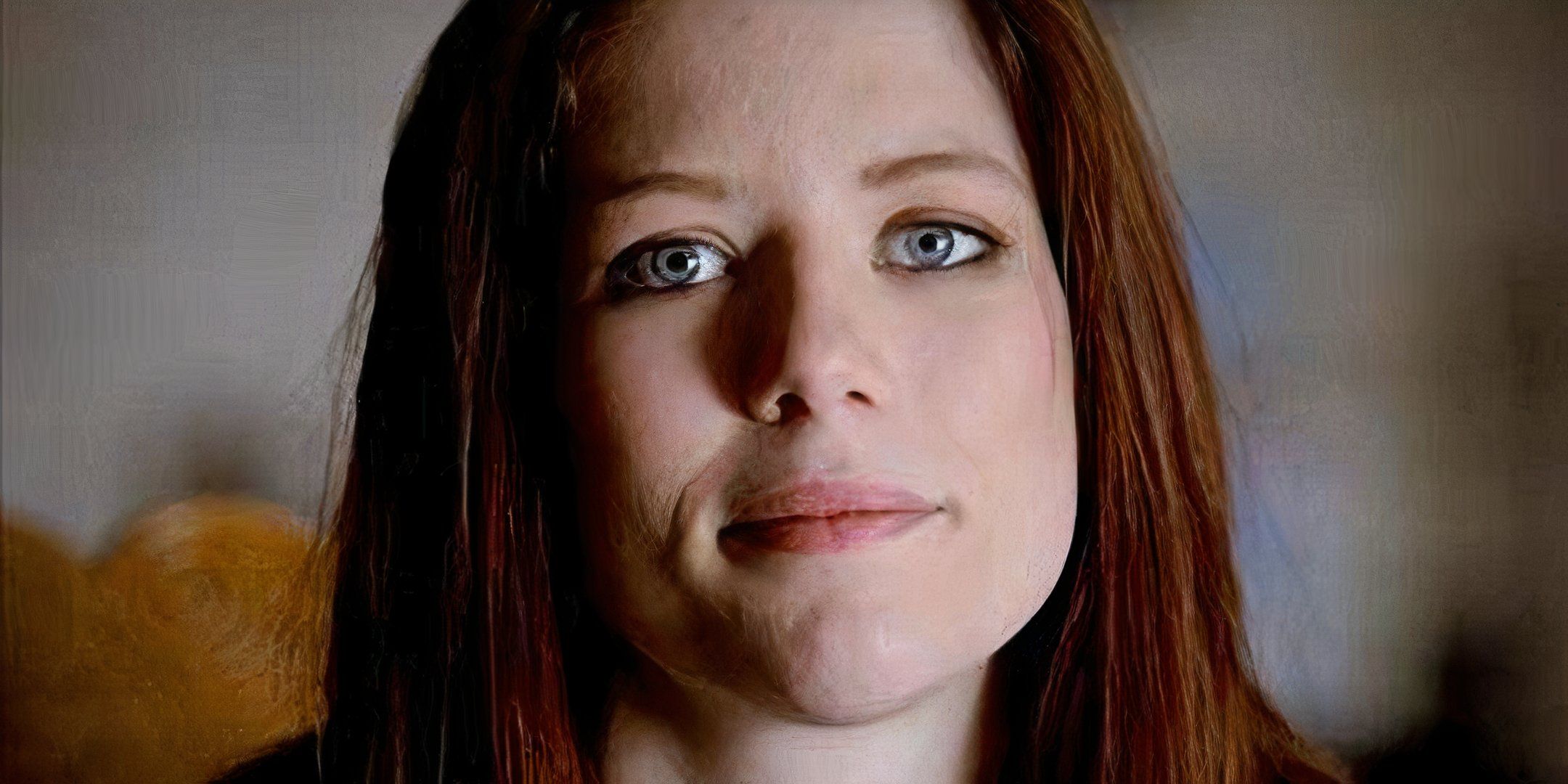 A woman looks directly at the camera with a slight smile. 
