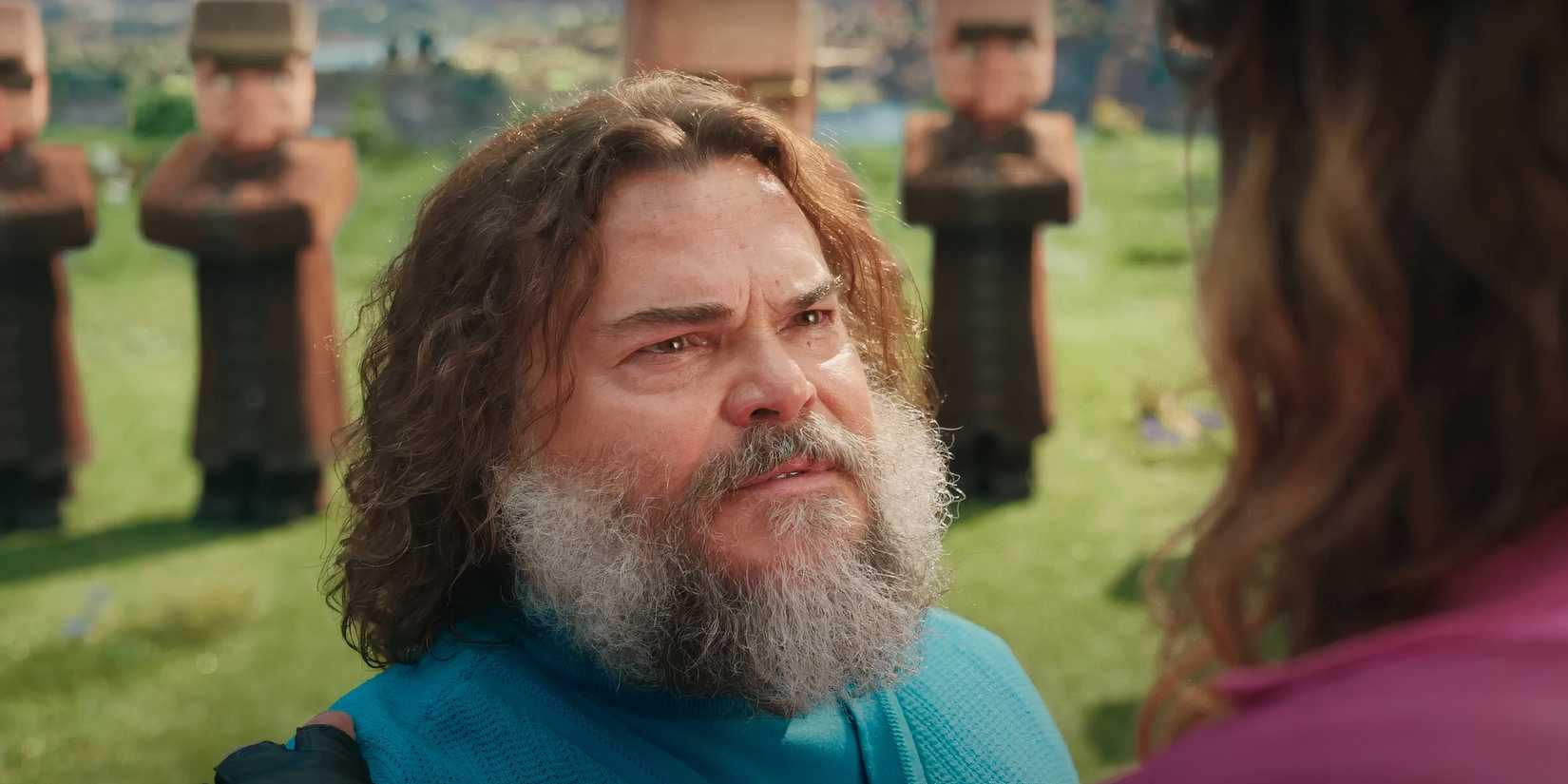 Jack Black looking sad while staring at Jason Momoa in A Minecraft Movie