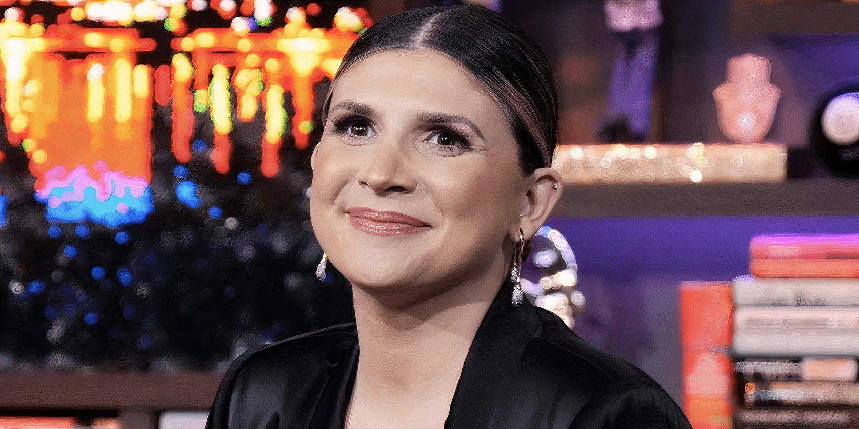 Janet Caperna from The Valley smiling on the set of Watch What Happens Live.