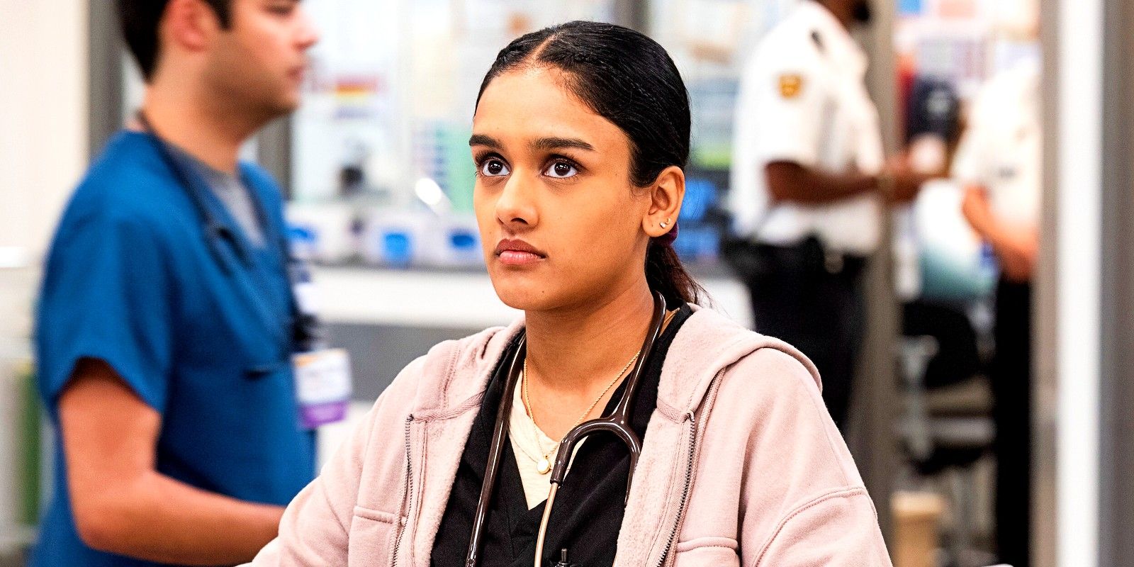 Javadi looking up in the middle of the emergency department in The Pitt season 1