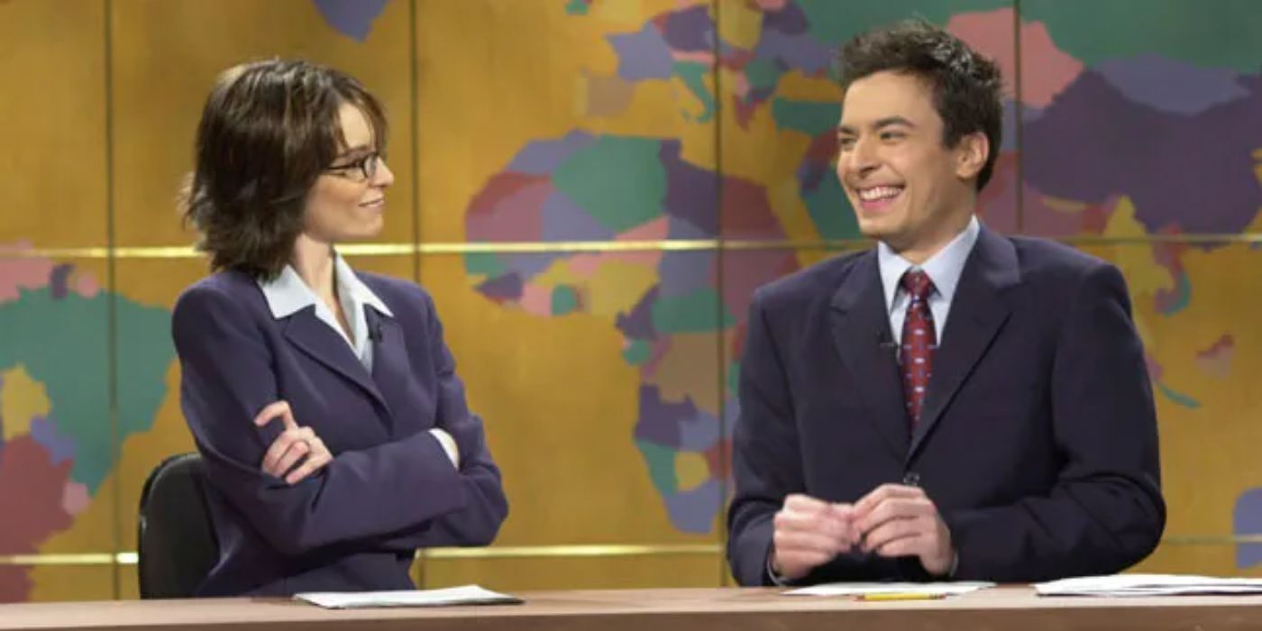 Jimmy Fallon laughing with Tina Fey during Weekend Update on Saturday Night Live