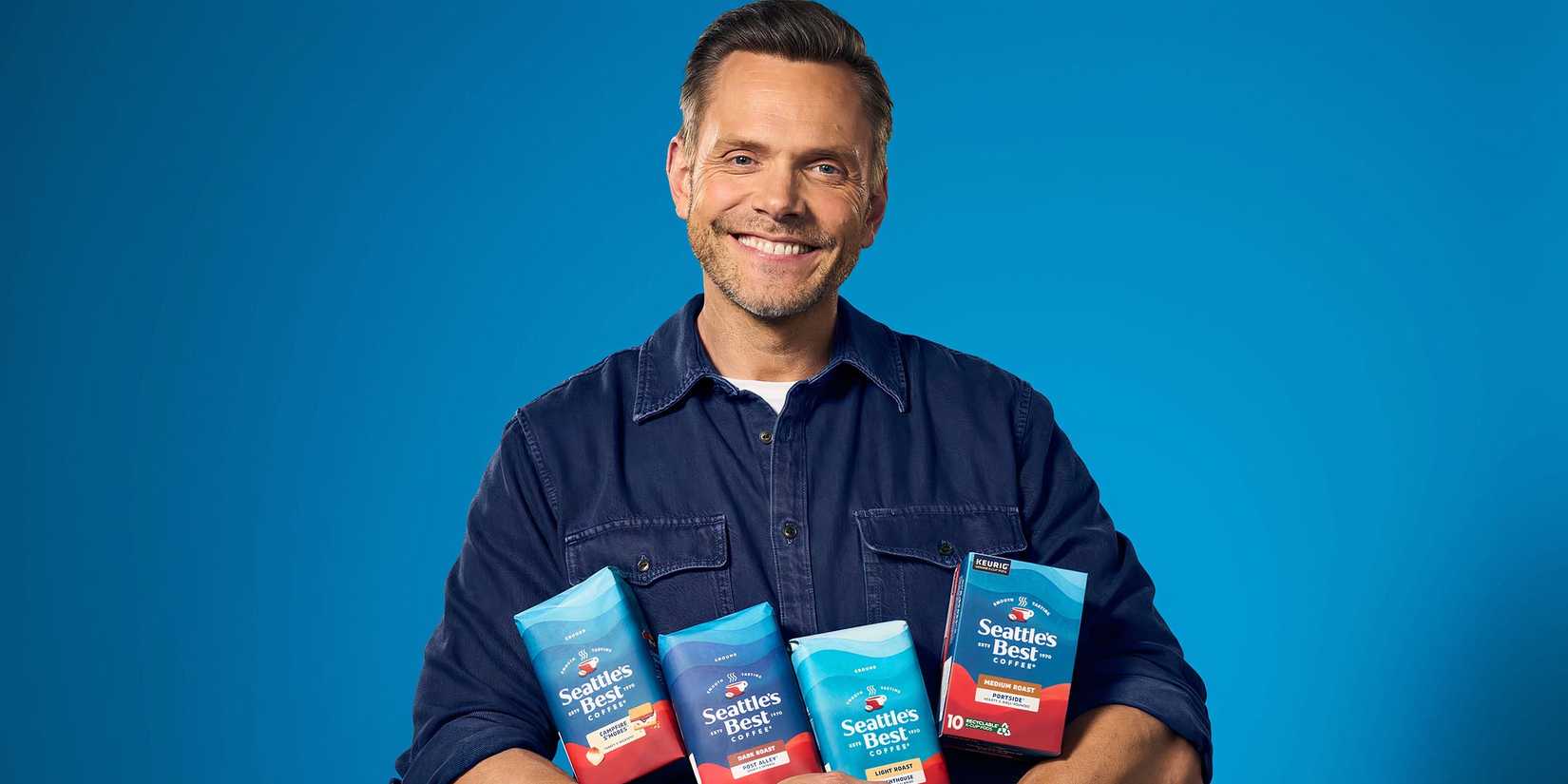 Joel McHale holding a selection of Seattle's Best Coffee bags