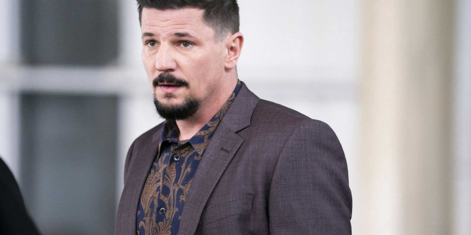 Law & Order: Organized Crime Joey standing in a suit jacket