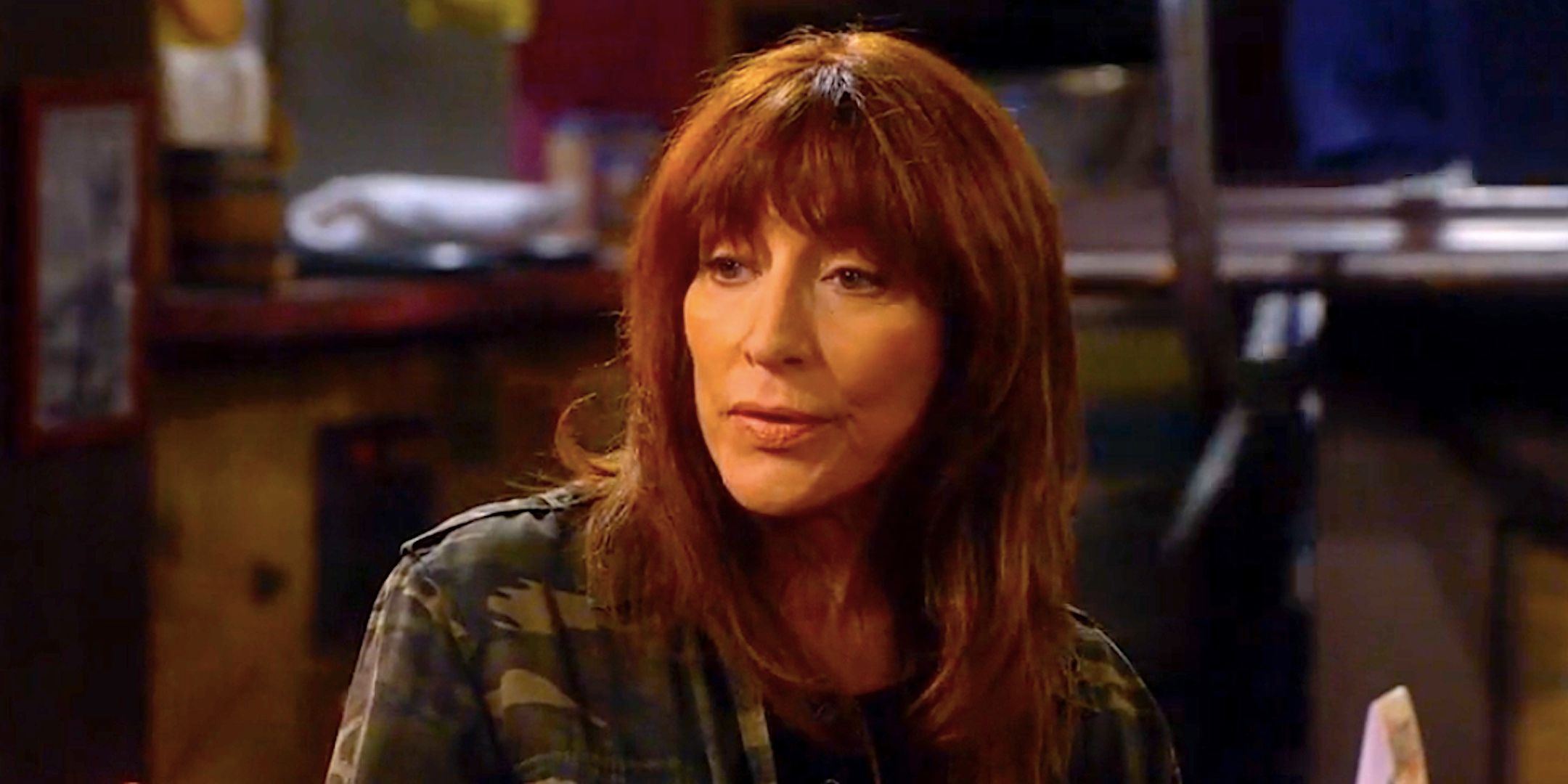 Katey Sagal&rsquo;s Louise sits at a bar table in The Conners season 7 episode 1