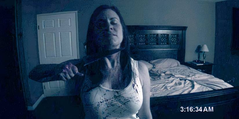 Katie with a kinfe held to her throat in the alternate Paranormal Activity ending