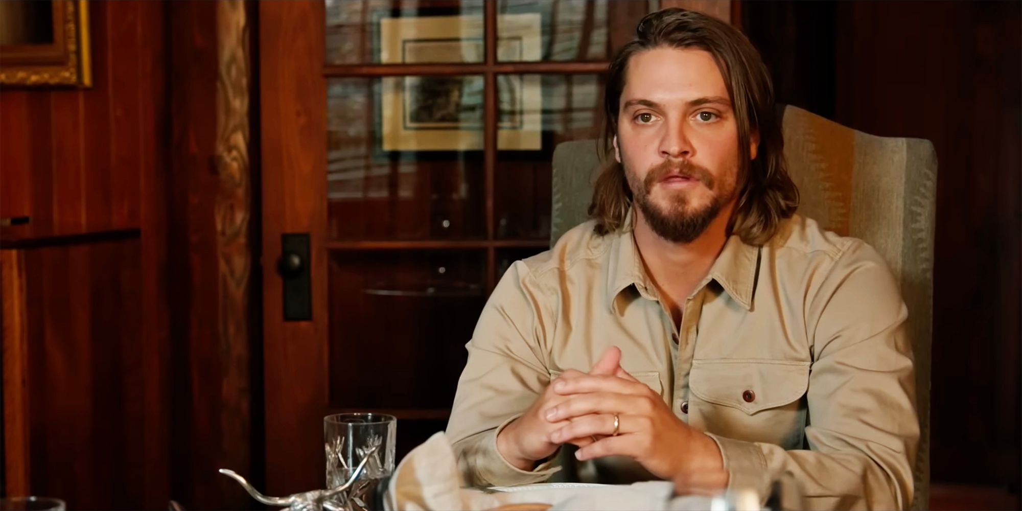 Kayce looks surprised in Yellowstone while sitting at the dinner table