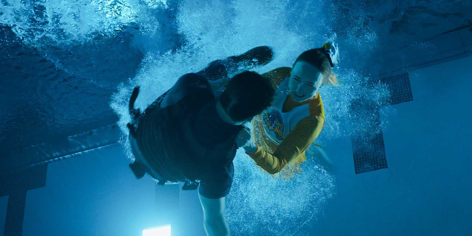 Kevin Bacon's Hub being dragged down into a pool by a cheerleader in The Bondsman