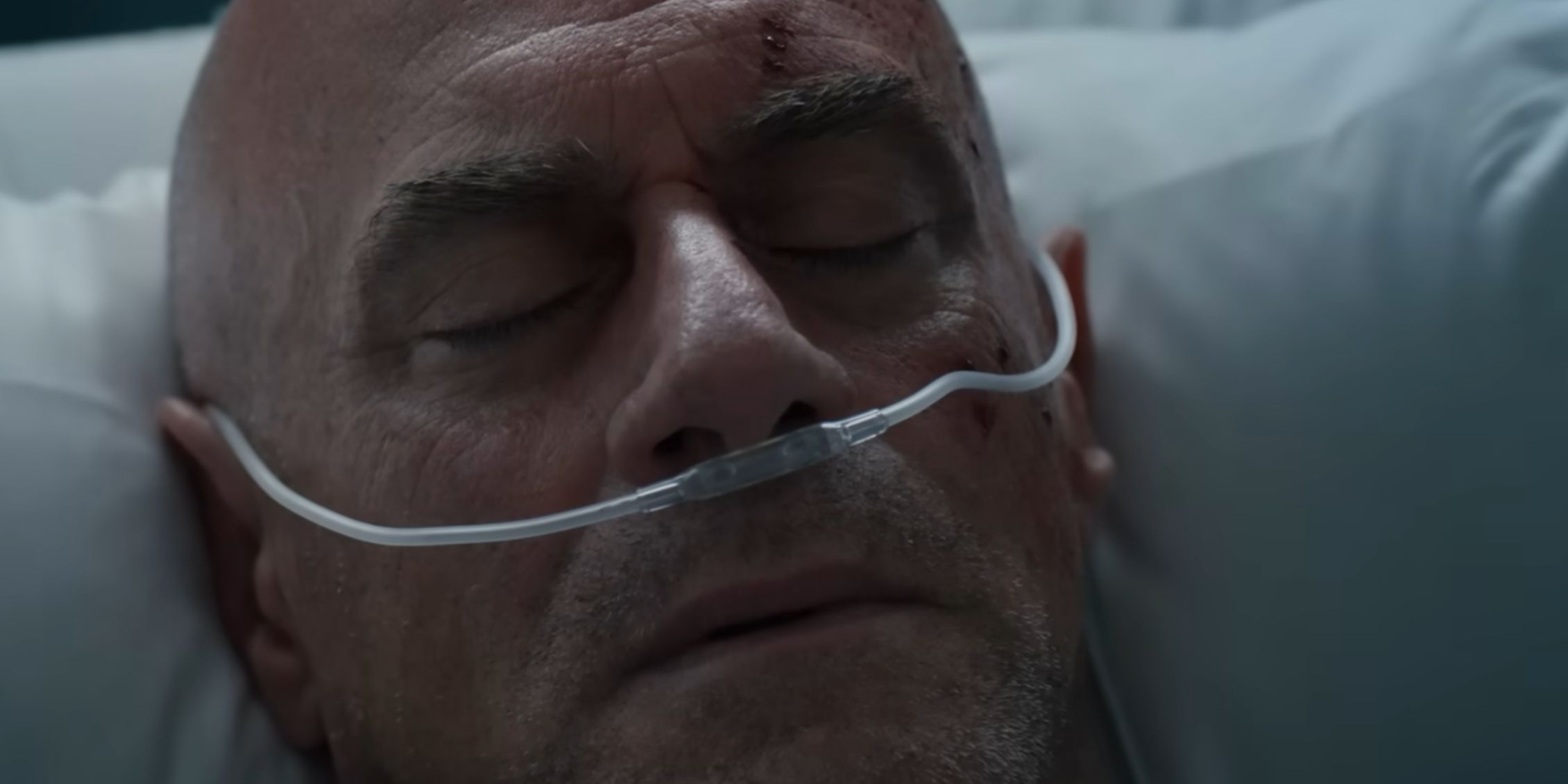 Law &amp; Order Organized Crime Stabler lying in a hospital bed with an oxygen mask on