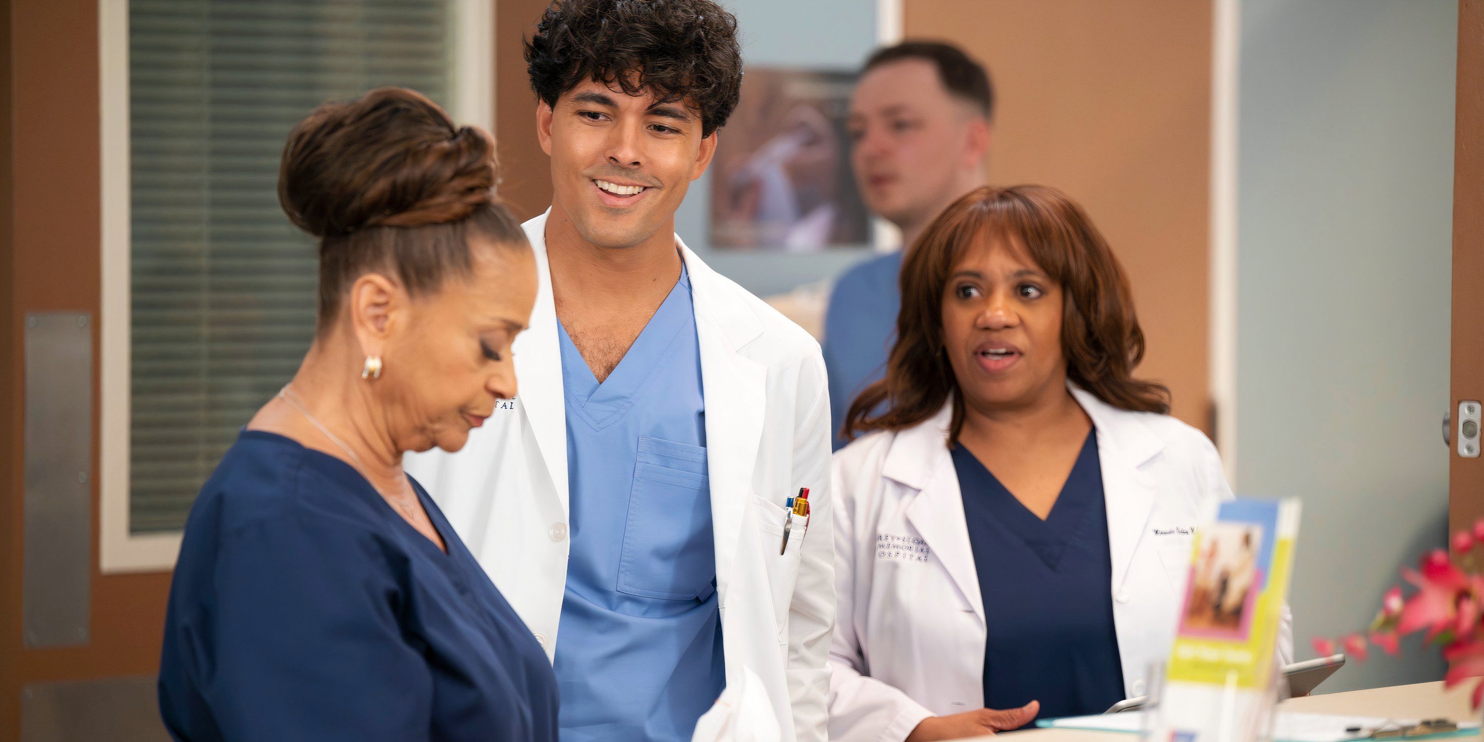 Lucas and Bailey approach Catherine at a desk in Grey's Anatomy season 21 episode 15