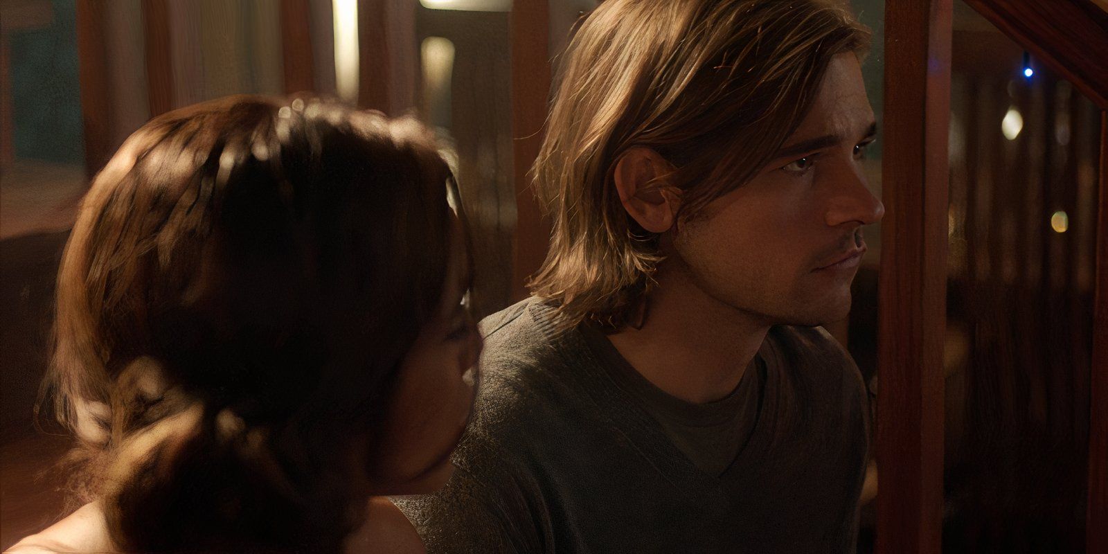 Margo looks at Quentin while sitting on the stairs in The Magicians season 1