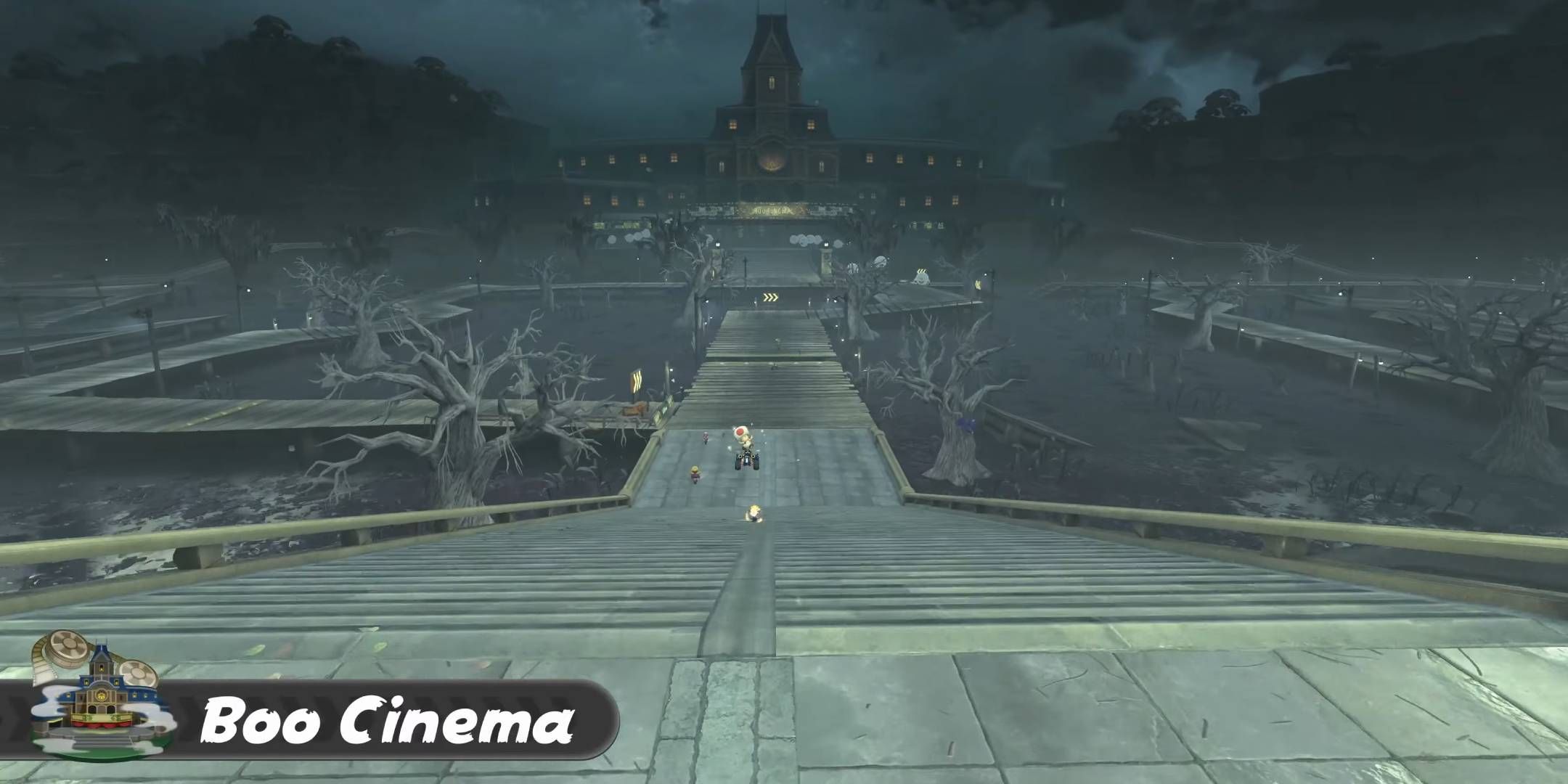 A wide shot of the Mario Kart World track Boo Cinema, with the titular cinema in the distance.